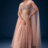 11043-peach-ruched-lehenga-with-embroidered-blouse-and-net-cape-1.webp Peach Ruched Lehenga With Embroidered Blouse and Net Cape