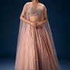 11043-peach-ruched-lehenga-with-embroidered-blouse-and-net-cape-3.webp Peach Ruched Lehenga With Embroidered Blouse and Net Cape