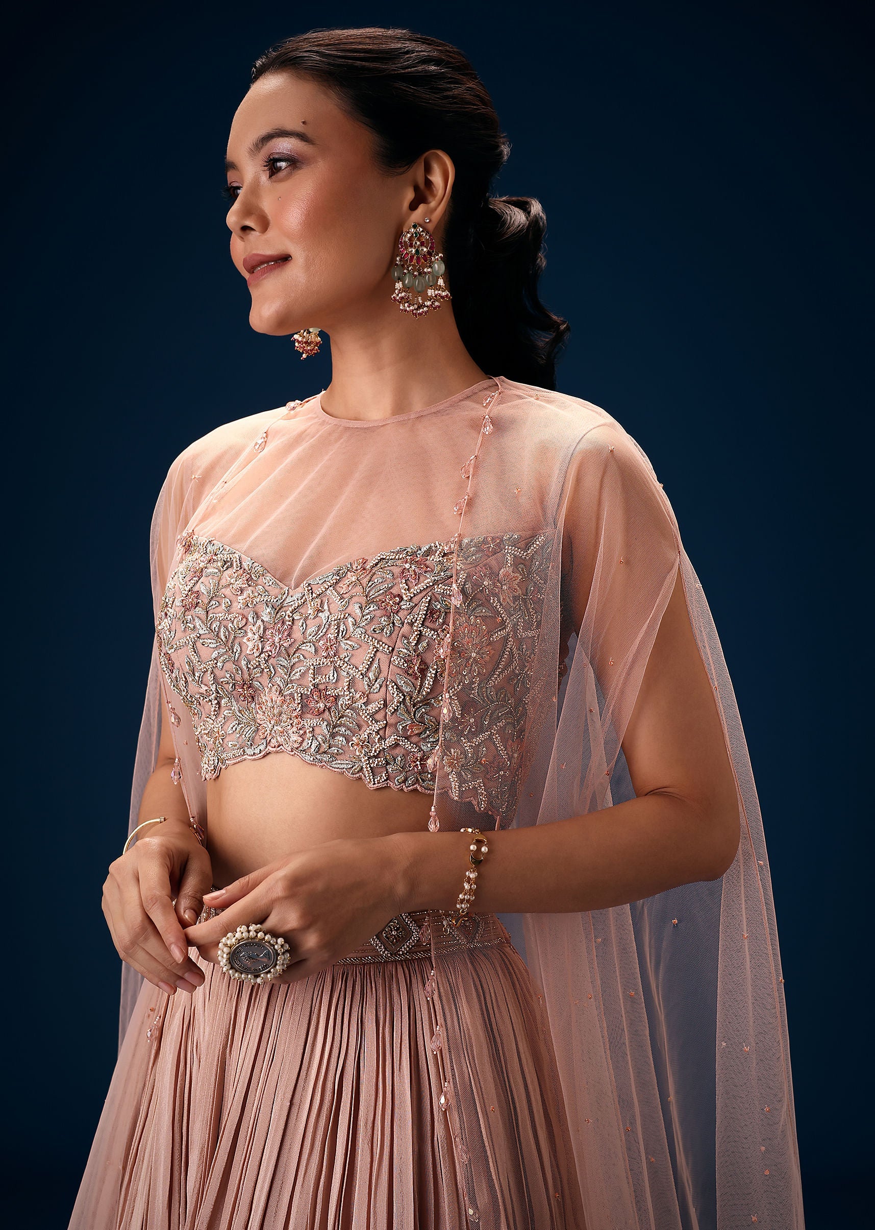 11043-peach-ruched-lehenga-with-embroidered-blouse-and-net-cape-4.jpg Peach Ruched Lehenga With Embroidered Blouse and Net Cape