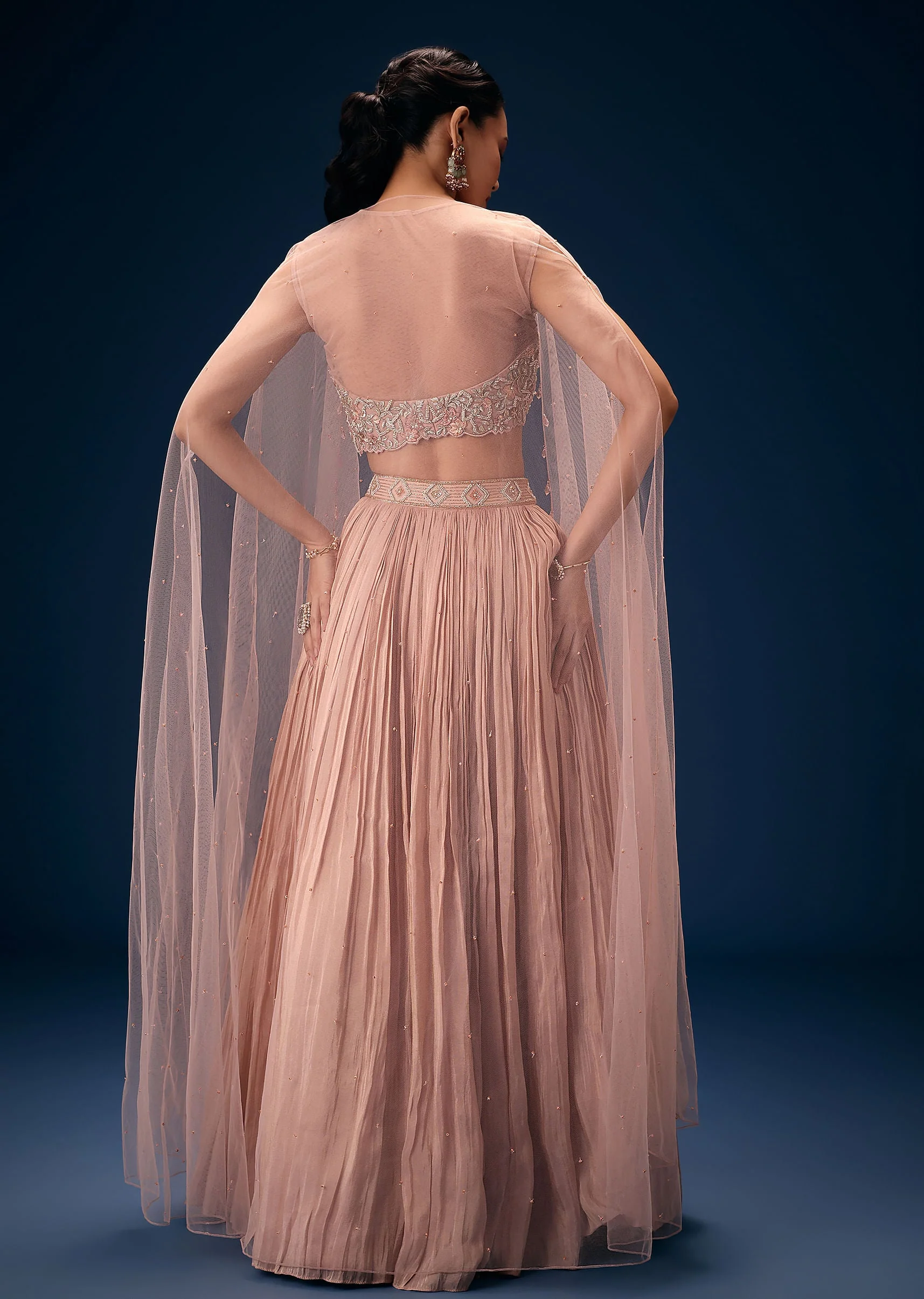 11043-peach-ruched-lehenga-with-embroidered-blouse-and-net-cape-5.webp Peach Ruched Lehenga With Embroidered Blouse and Net Cape
