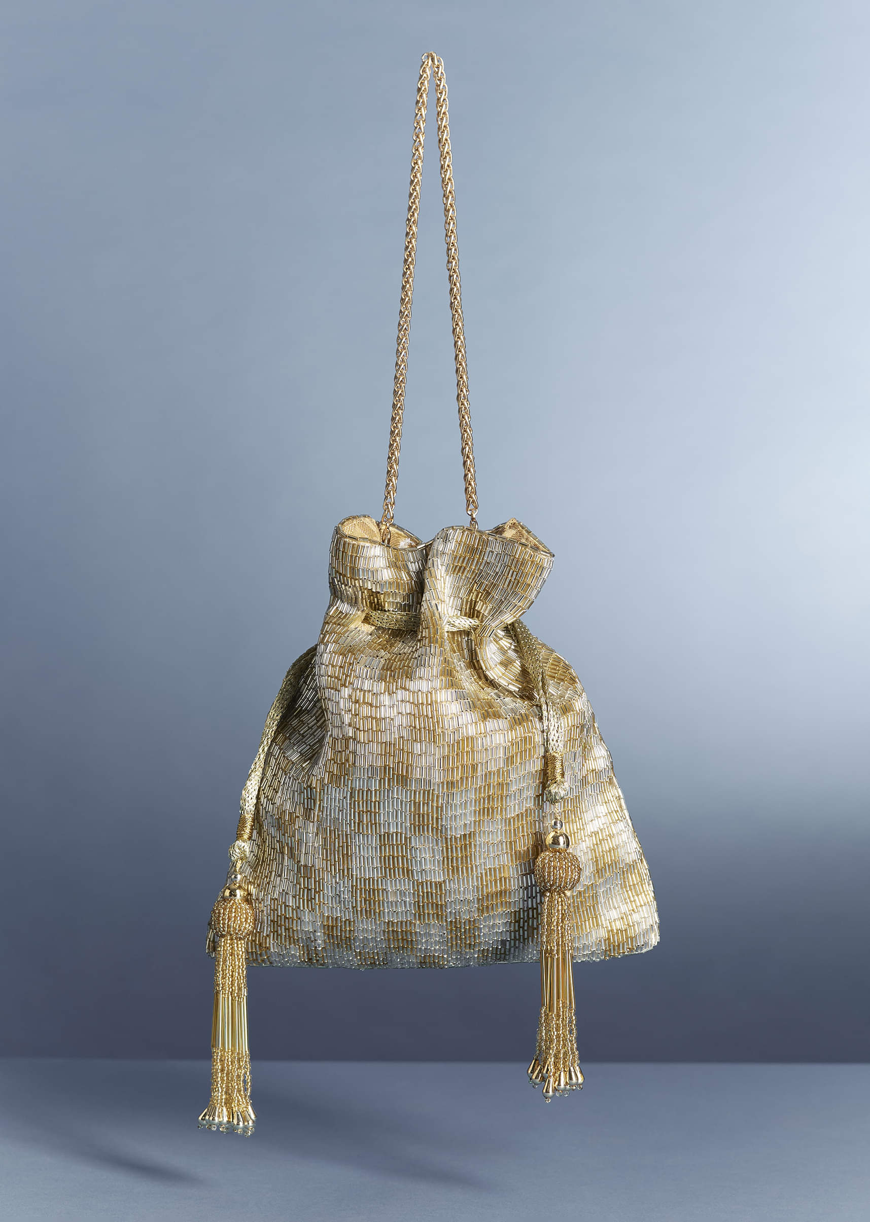 11086-silver-gold-metallic-tassel-potli-1.jpg Silver-Gold Metallic Tassel Potli