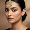 Kundan Maang Tikka With Green Gemstones And Pearl Drops