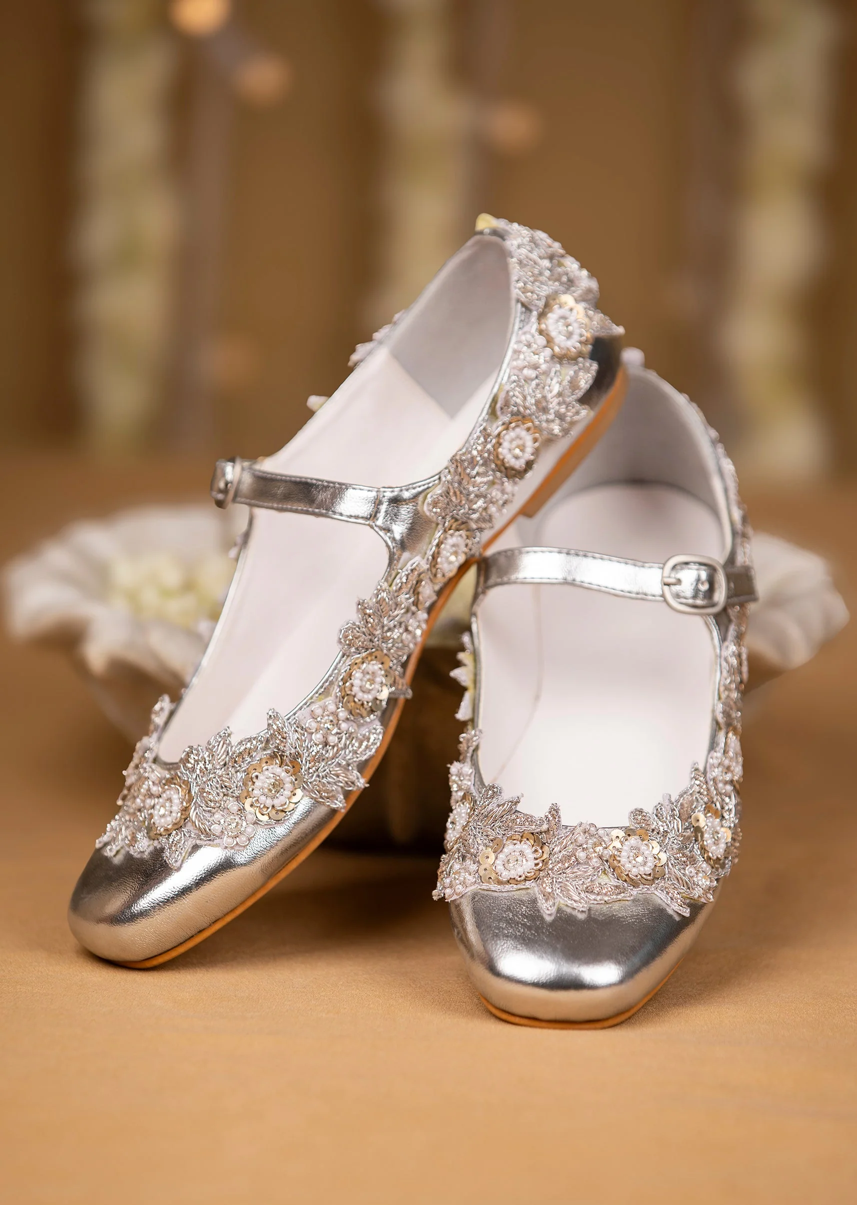 11974-silver-hand-embroidered-pearl-floral-juttis-1.webp Silver Hand Embroidered Pearl Floral Juttis