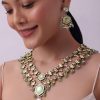 White Layered Kundan Necklace And Earring Set With Carved Motif