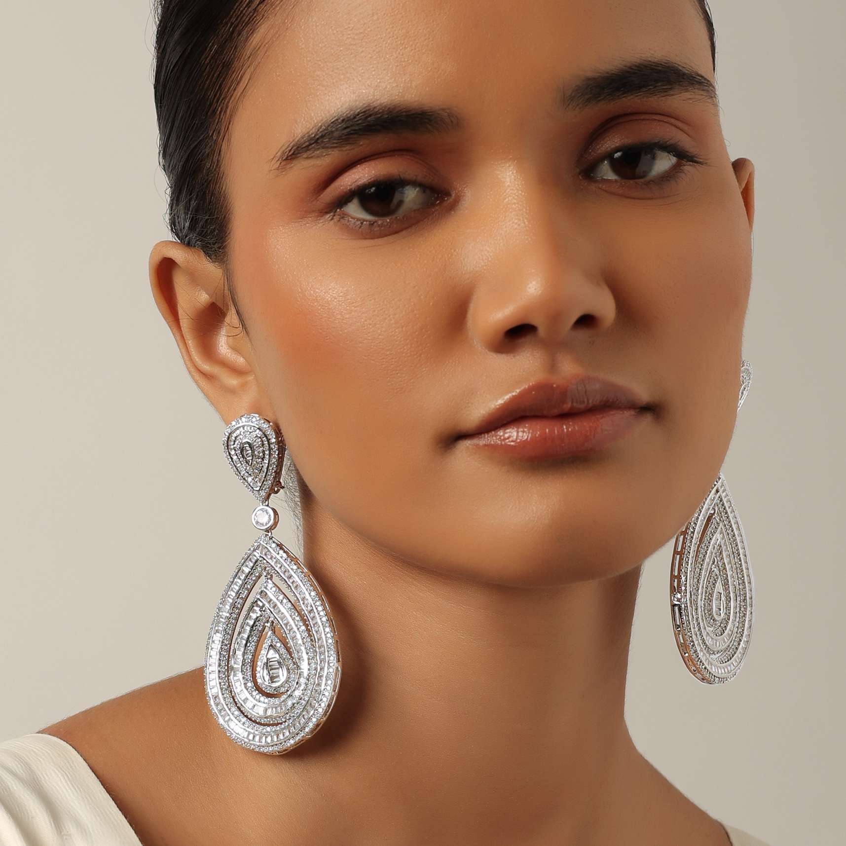 12171-silver-finish-statement-danglers-with-zirconia-stones-and-teardrop-motif-1.jpg Silver Finish Statement Danglers With Zirconia Stones And Teardrop Motif