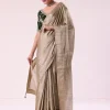 Silver Zari Tissue Saree With Embroidered Emerald Green Stitched Blouse