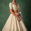 Ivory Raw Silk Hand Embroidered Lehenga Set In Cutdana Work
