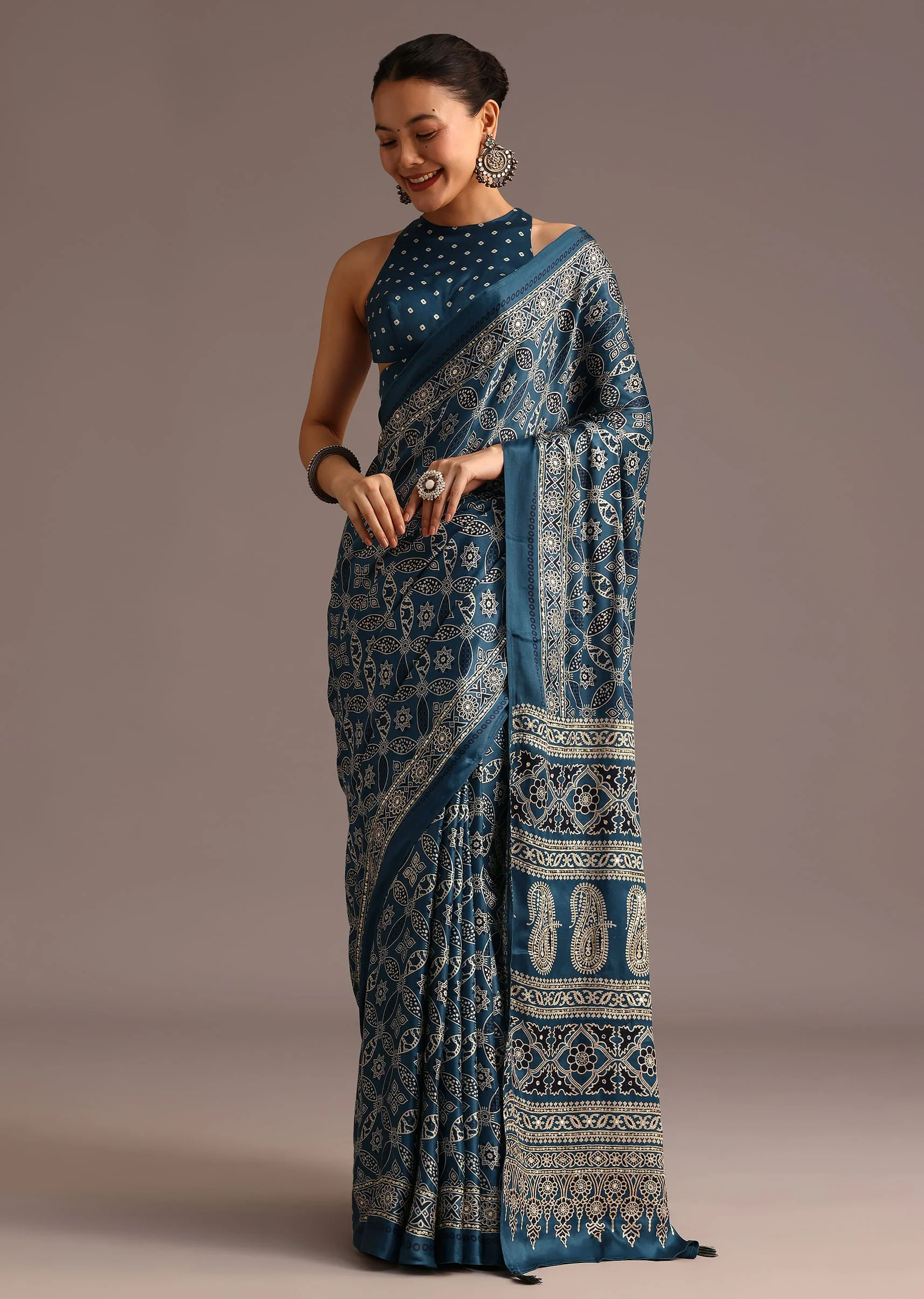 16773-teal-satin-ajrakh-print-saree-with-mirror-embellished-border-and-pallu-1.webp Teal Satin Ajrakh Print Saree With Mirror Embellished Border And Pallu