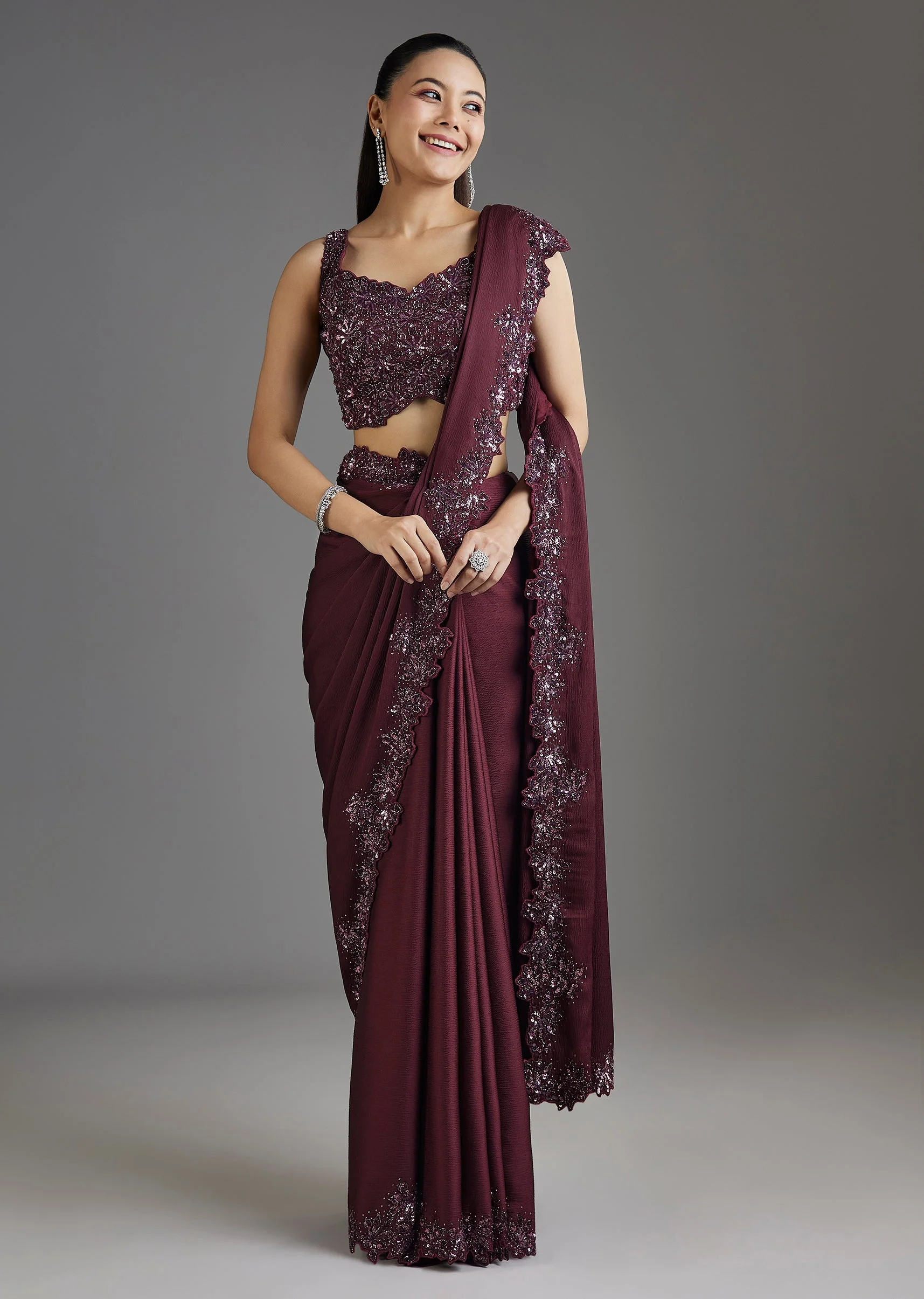 1972-wine-sequins-embellished-chiffon-saree-with-sleeveless-blouse-1.webp Wine Sequins Embellished Chiffon Saree With Sleeveless Blouse