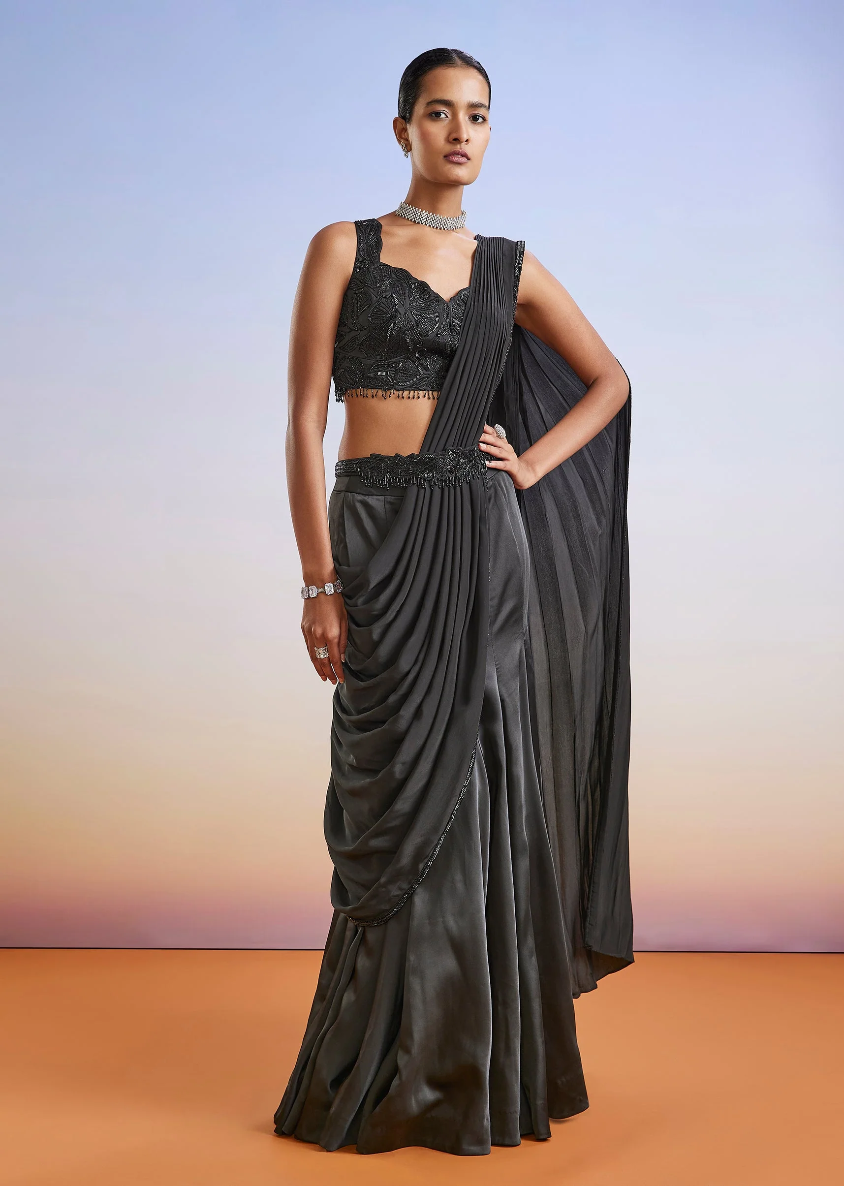 3929-black-satin-ready-pleated-saree-with-embroidered-blouse-and-belt-1.webp Black Satin Ready Pleated Saree With Embroidered Blouse And Belt