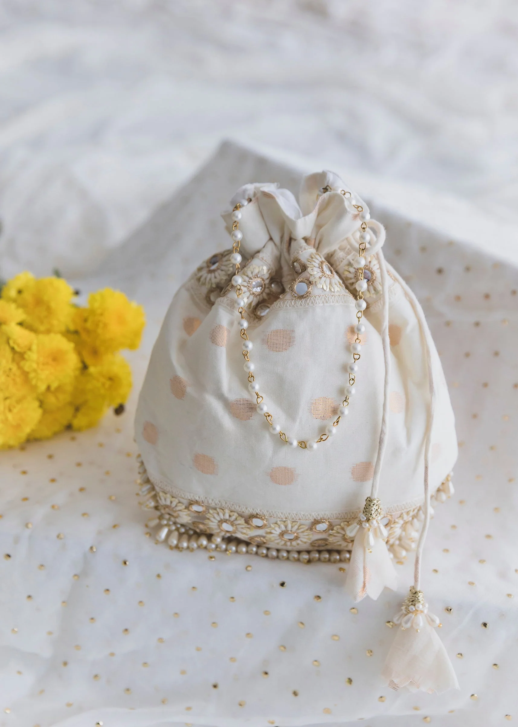 426-cream-cotton-potli-with-embroidery-and-mirror-work-1.webp Cream Cotton Potli With Embroidery And Mirror Work
