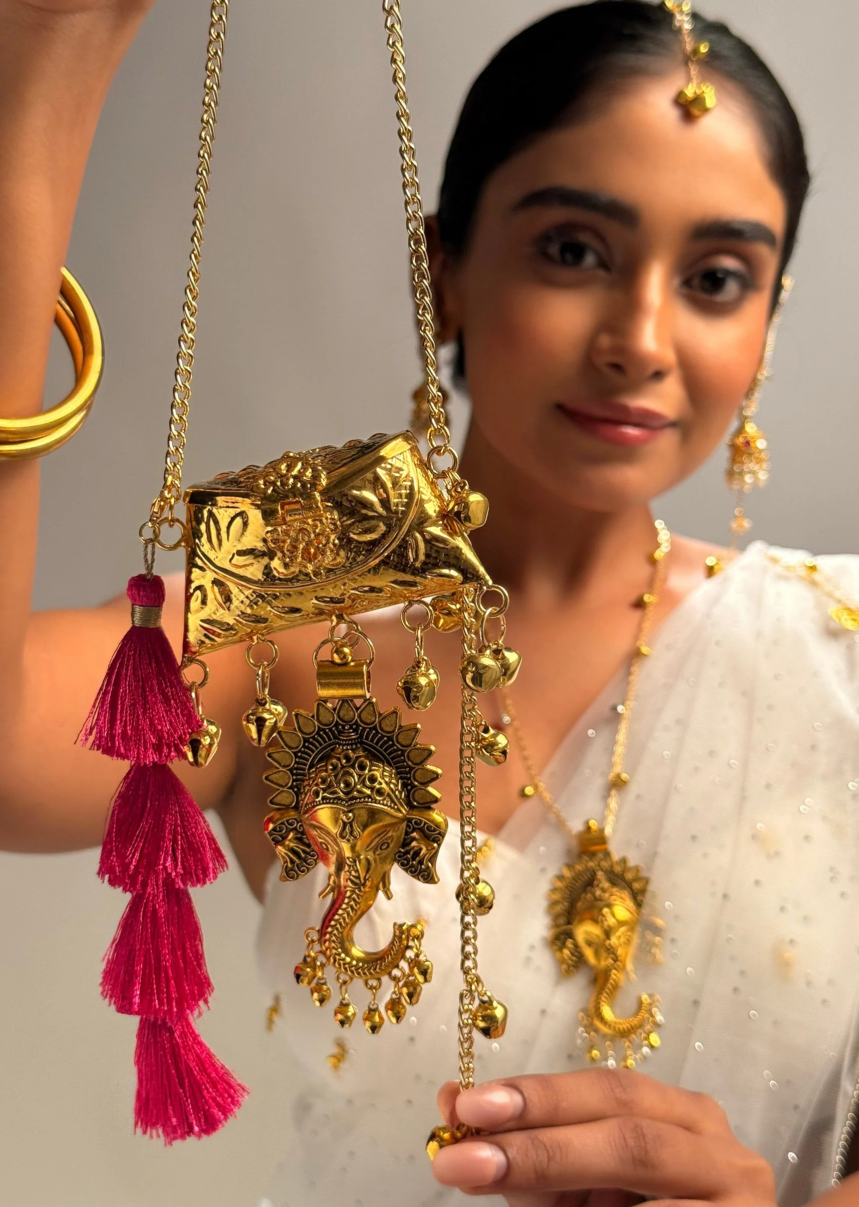 449-gold-ganesha-charm-potli-bag-1.webp Gold Ganesha Charm Potli Bag