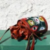 Handcrafted leather potli bag with bold colourful eye embroidery