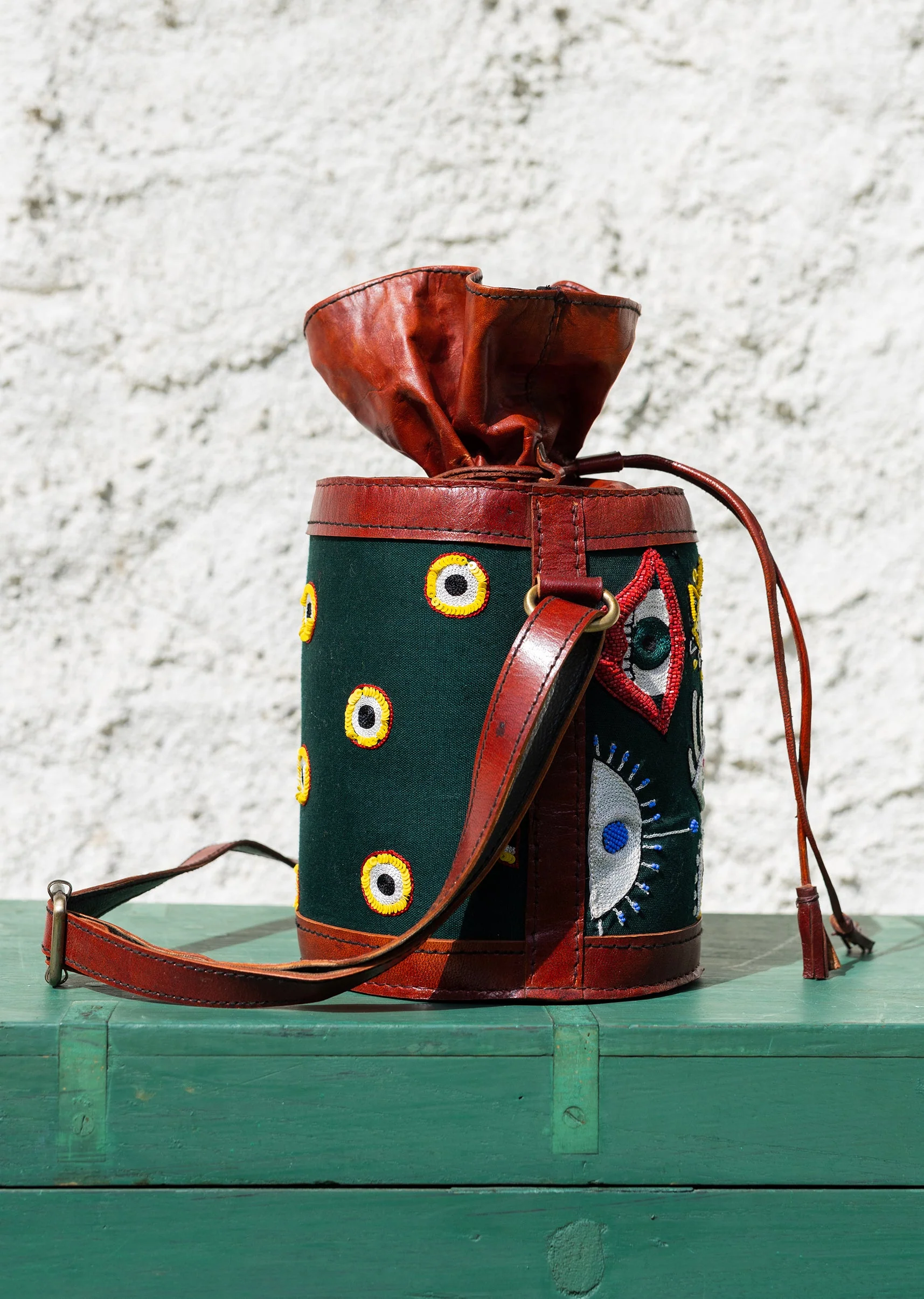 Handcrafted leather potli bag with bold colourful eye embroidery