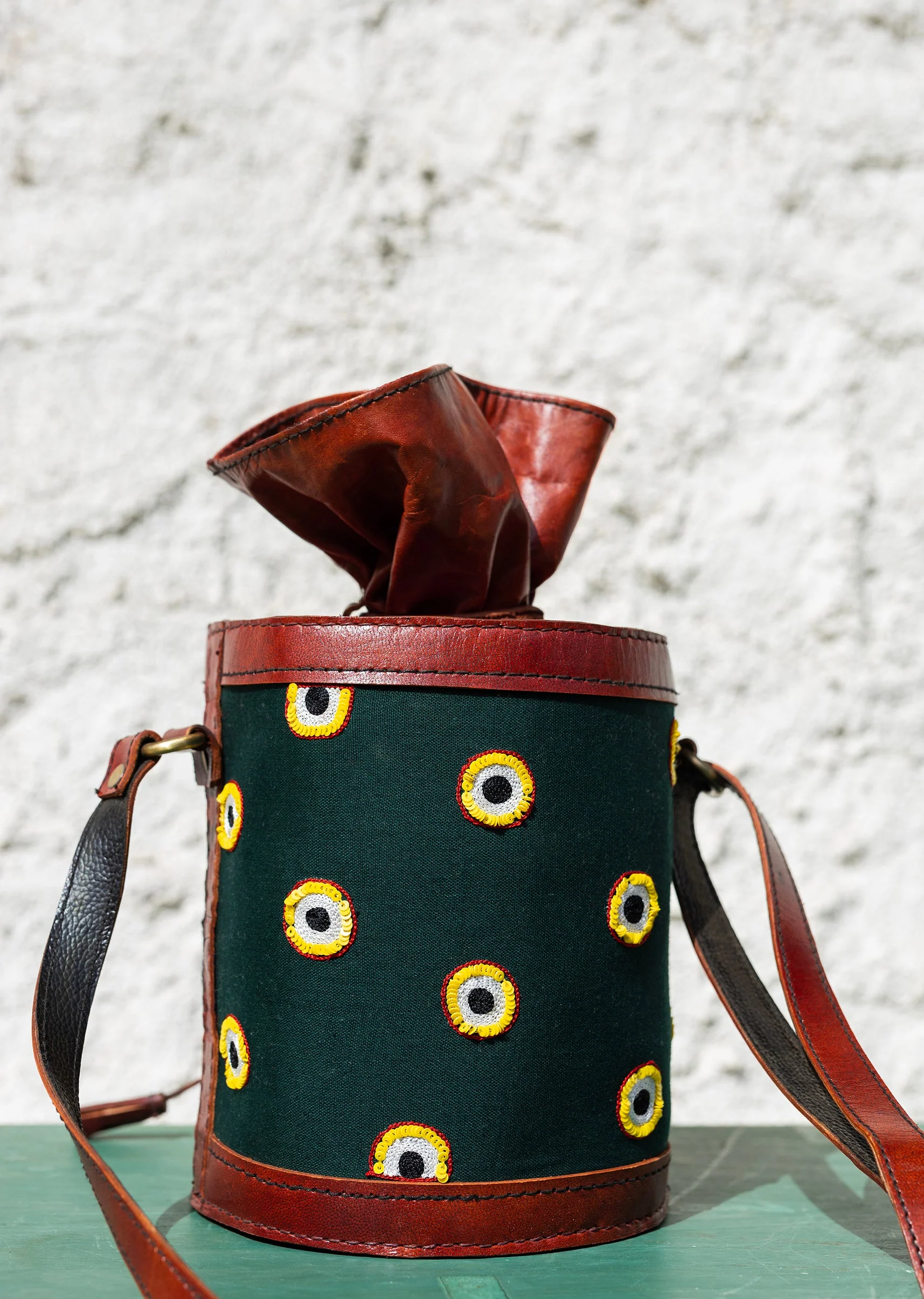 Handcrafted leather potli bag with bold colourful eye embroidery
