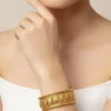 536-gold-toned-bangles-with-temple-style-motifs-1.webp Gold Toned Bangles With Temple Style Motifs
