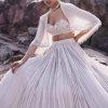 White Ruched Lehenga With Spaghetti Blouse And Cape