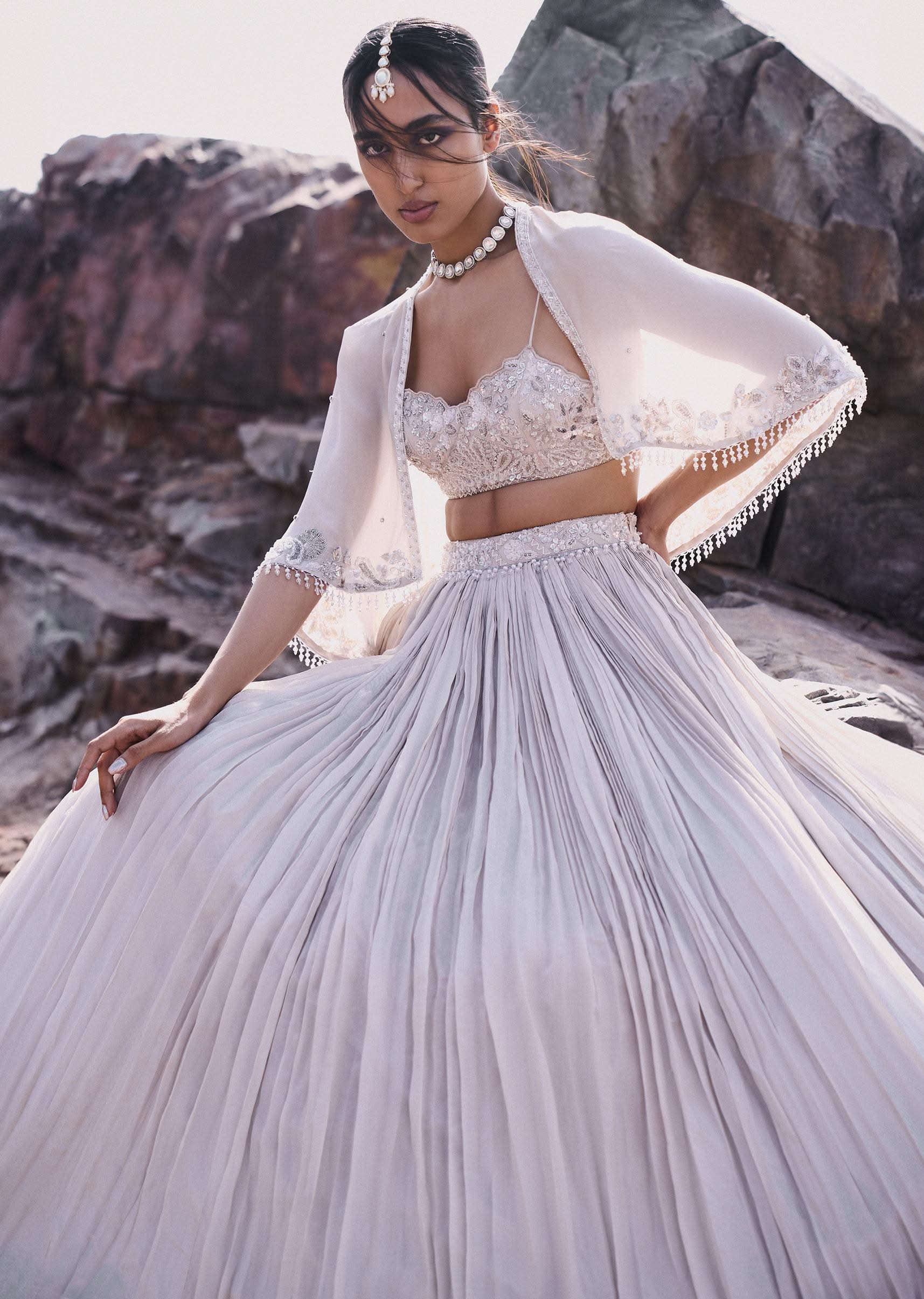 5517-white-ruched-lehenga-with-spaghetti-blouse-and-cape-1.jpg White Ruched Lehenga With Spaghetti Blouse And Cape