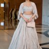 White Ruched Lehenga With Spaghetti Blouse And Cape