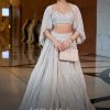 White Ruched Lehenga With Spaghetti Blouse And Cape