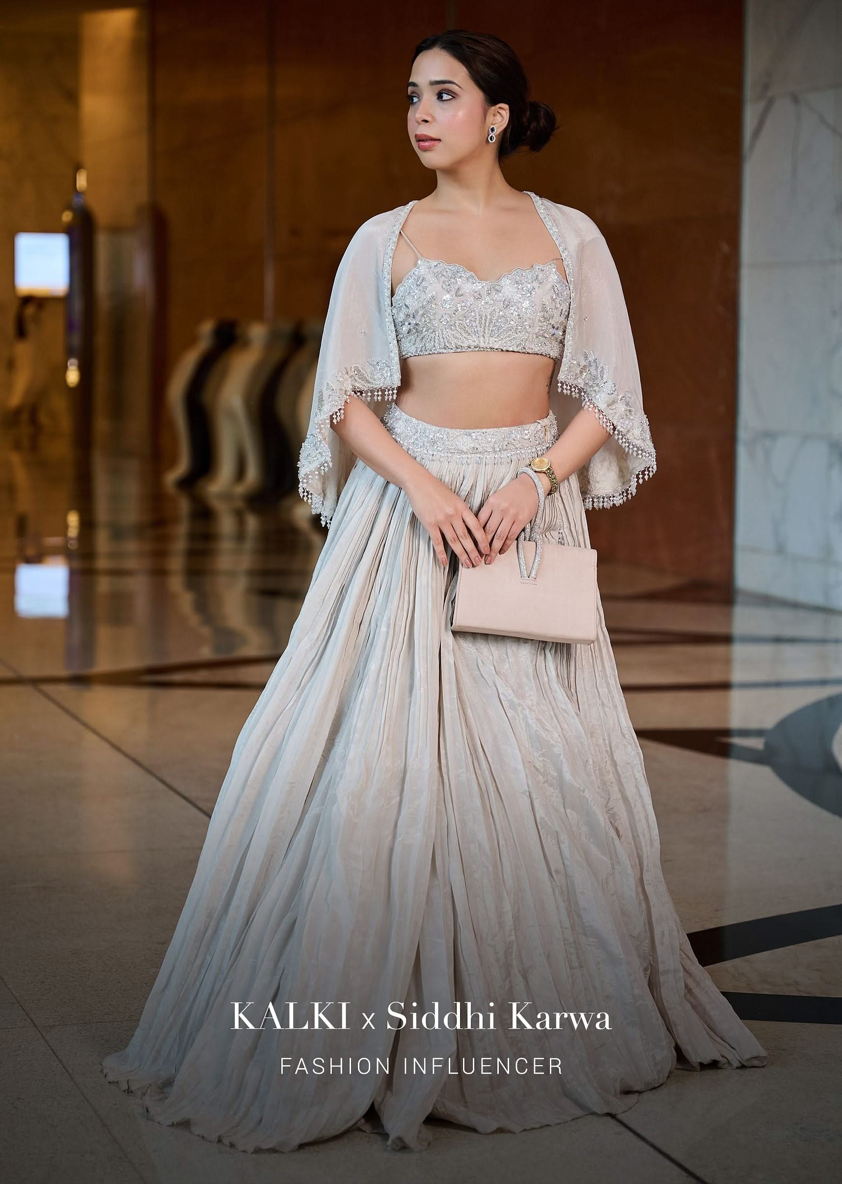 White Ruched Lehenga With Spaghetti Blouse And Cape