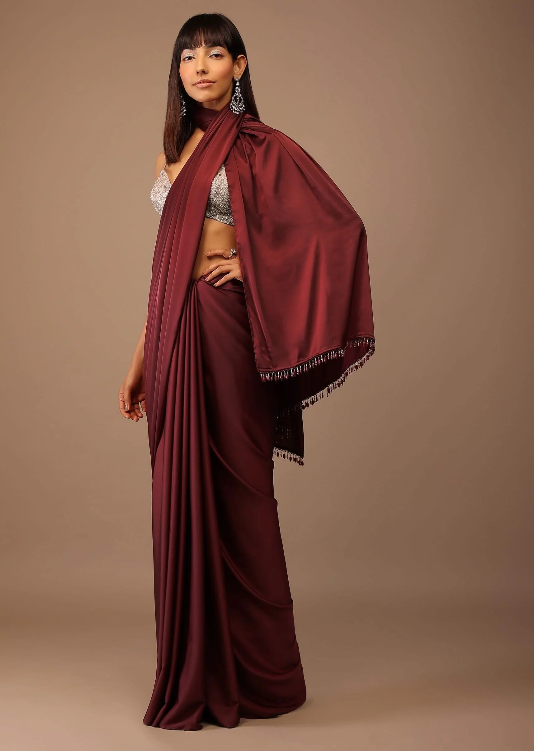 6863-blood-red-satin-saree-with-fringes-on-the-pallu-paired-with-hand-embroidered-bustier-1.webp Blood Red Satin Saree With Fringes On The Pallu Paired With Hand Embroidered Bustier