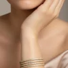 732-gold-finish-bangles-with-traditional-temple-motifs-and-white-pearls-1.webp Gold Finish Bangles With Traditional Temple Motifs And White Pearls