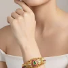 8441-gold-finish-bangle-with-traditional-temple-motifs-and-green-and-pink-simulated-stones-with-zirconia-accents-1.webp Gold Finish Bangle With Traditional Temple Motifs And Green and Pink Simulated Stones With Zirconia Accents