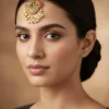 8472-gold-finish-maangtikka-with-temple-style-motifs-and-pink-and-green-simulated-stones-1.webp Gold Finish Maangtikka With Temple Style Motifs And Pink and Green Simulated Stones