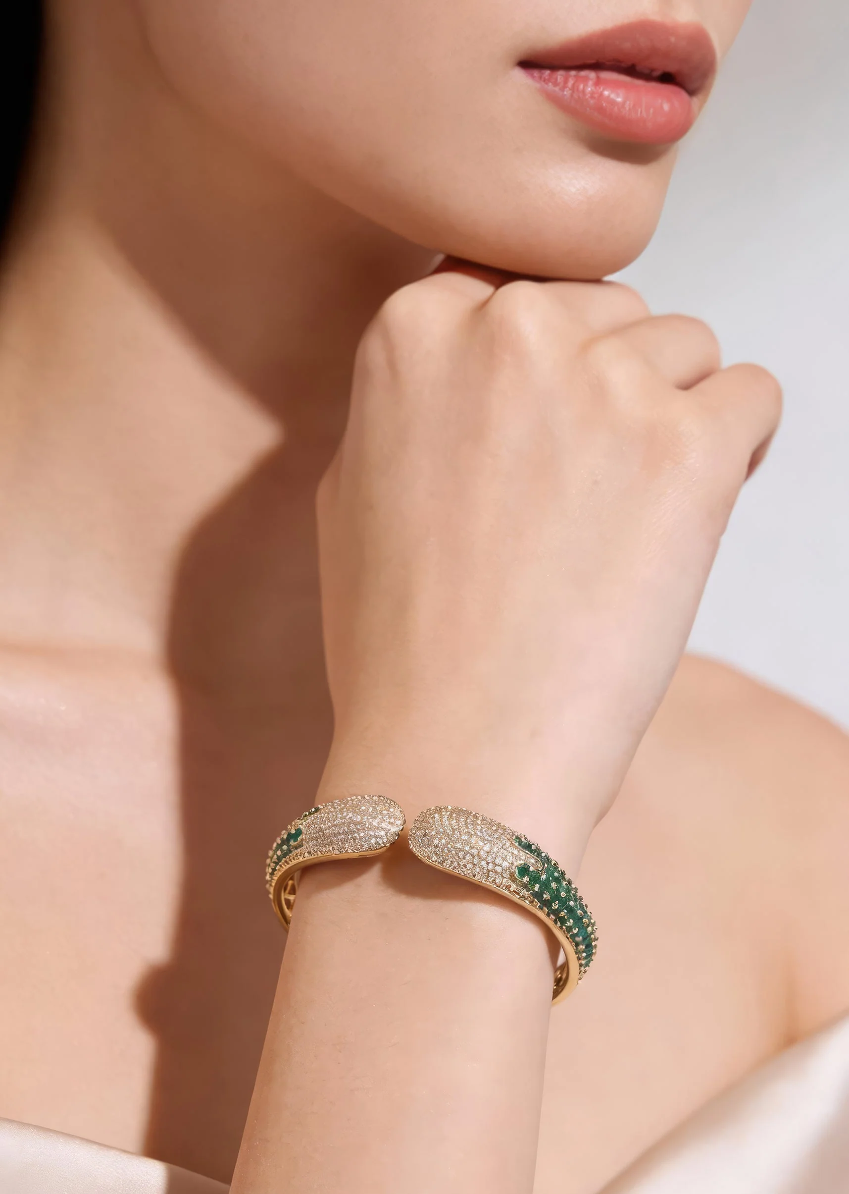 Gold Finish Bracelet In Mix Metal With Modern Cuff Style And Green Simulated Emerald And Cubic Zirconia Accents