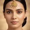 8487-gold-finish-maangtikka-with-temple-style-motifs-and-pink-green-and-off-white-simulated-stones-1.webp Gold Finish Maangtikka With Temple Style Motifs And Pink Green and Off White Simulated Stones