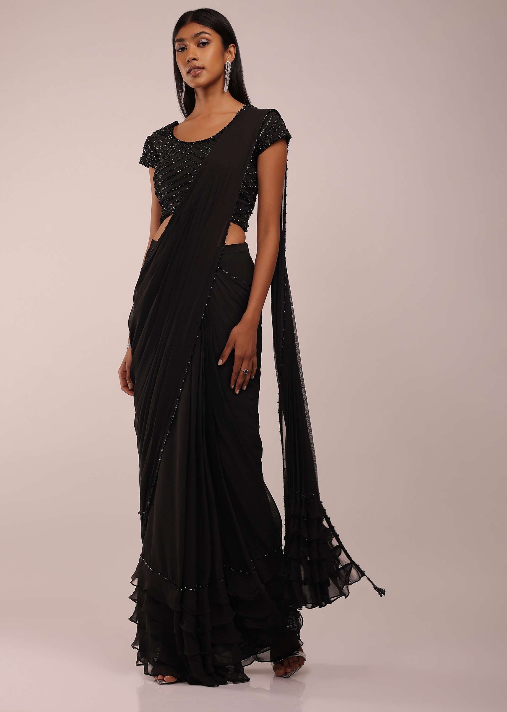 8674-pitch-black-saree-with-three-tones-of-layered-frills-on-the-bottom-embellished-in-stones-and-sequins-with-a-tassel-on-the-pallu-corner-1.jpg Pitch Black Saree With Three Tones Of Layered Frills On The Bottom Embellished In Stones And Sequins With A Tassel On The Pallu Corner