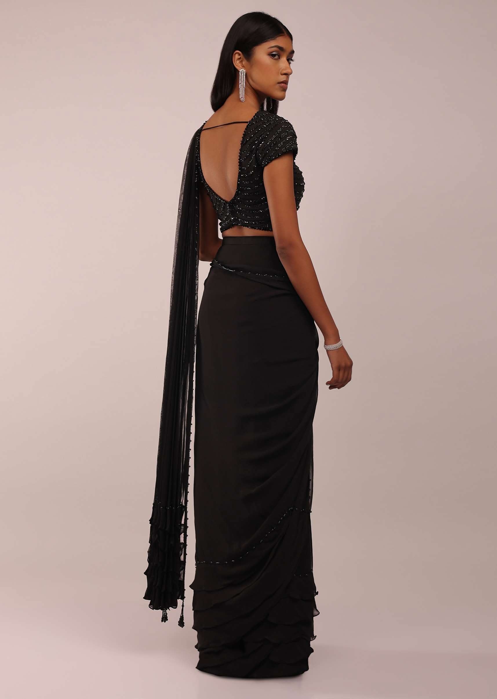8678-us-12-us-12-variation-5.jpg Pitch Black Saree With Three Tones Of Layered Frills On The Bottom Embellished In Stones And Sequins With A Tassel On The Pallu Corner