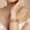 Gold Tone Bangles With Teardrop White Stones And Green Enamel