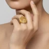 895-gold-finish-ring-with-temple-style-motifs-and-green-simulated-stones-1.webp Gold Finish Ring With Temple Style Motifs And Green Simulated Stones
