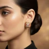 930-gold-toned-earrings-in-stud-style-with-enamel-stone-detailing-1.webp Gold Toned Earrings In Stud Style With Enamel Stone Detailing